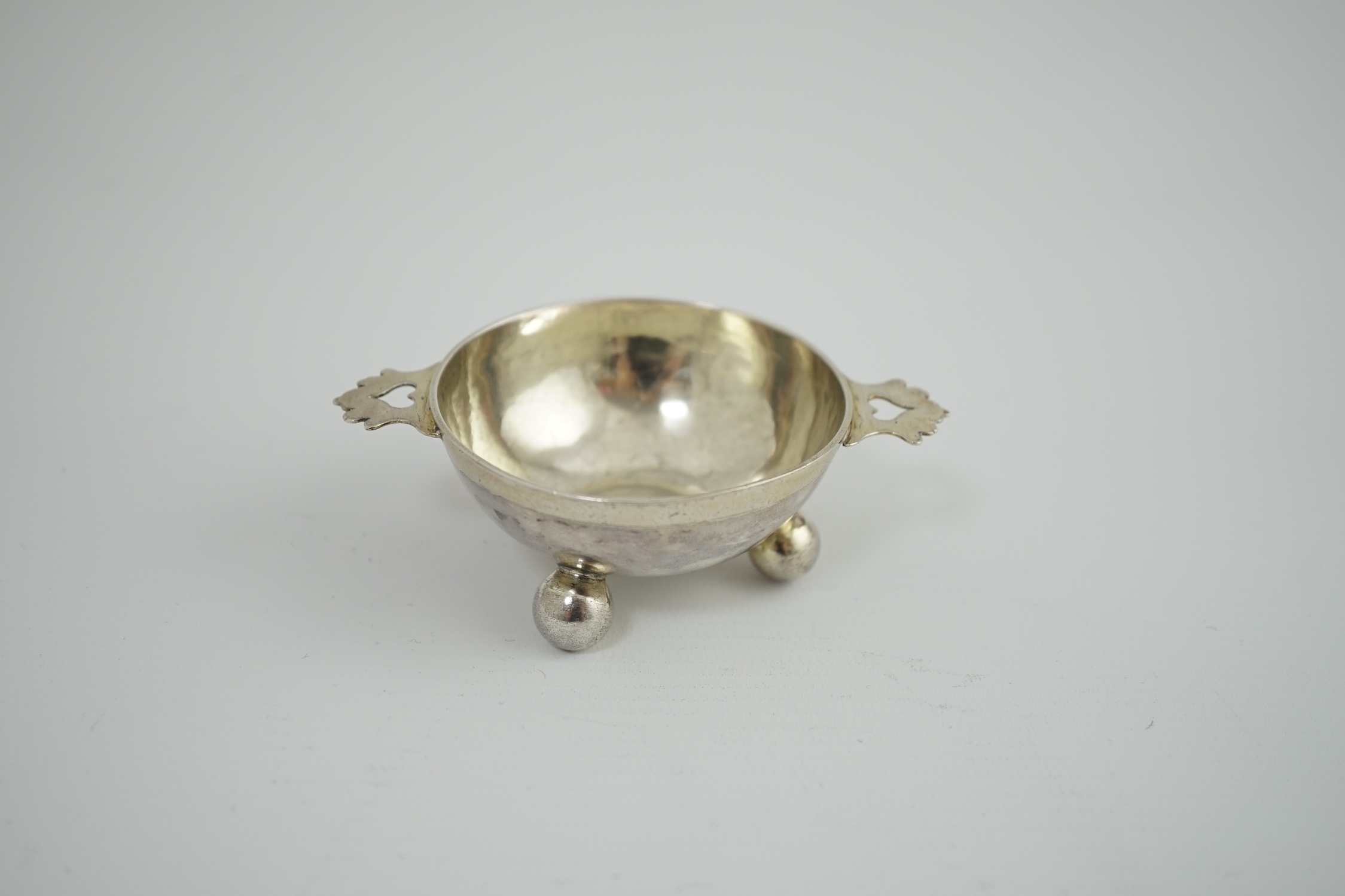 A late 17th century? German Nurnberg silver two handled wine taster, on three ball feet